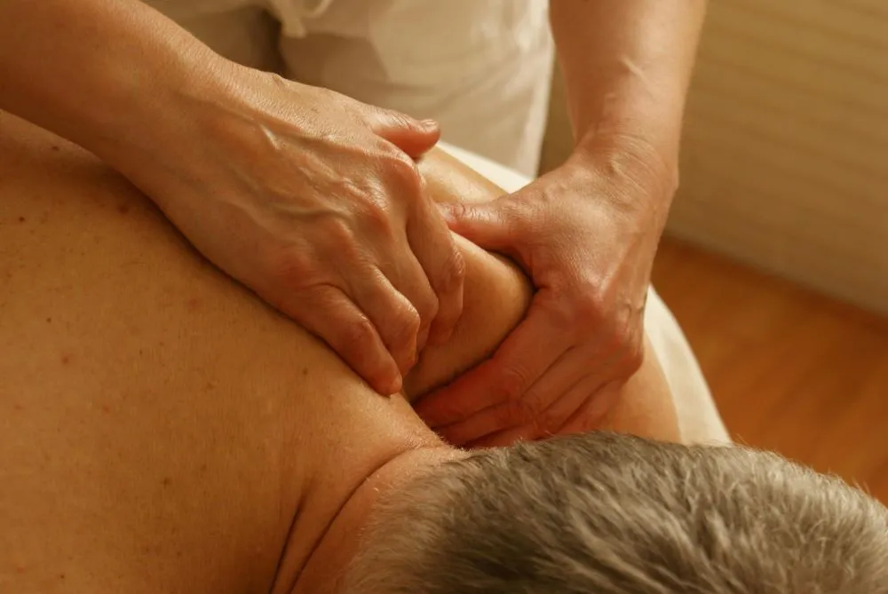 A therapist performing a deep tissue massage.