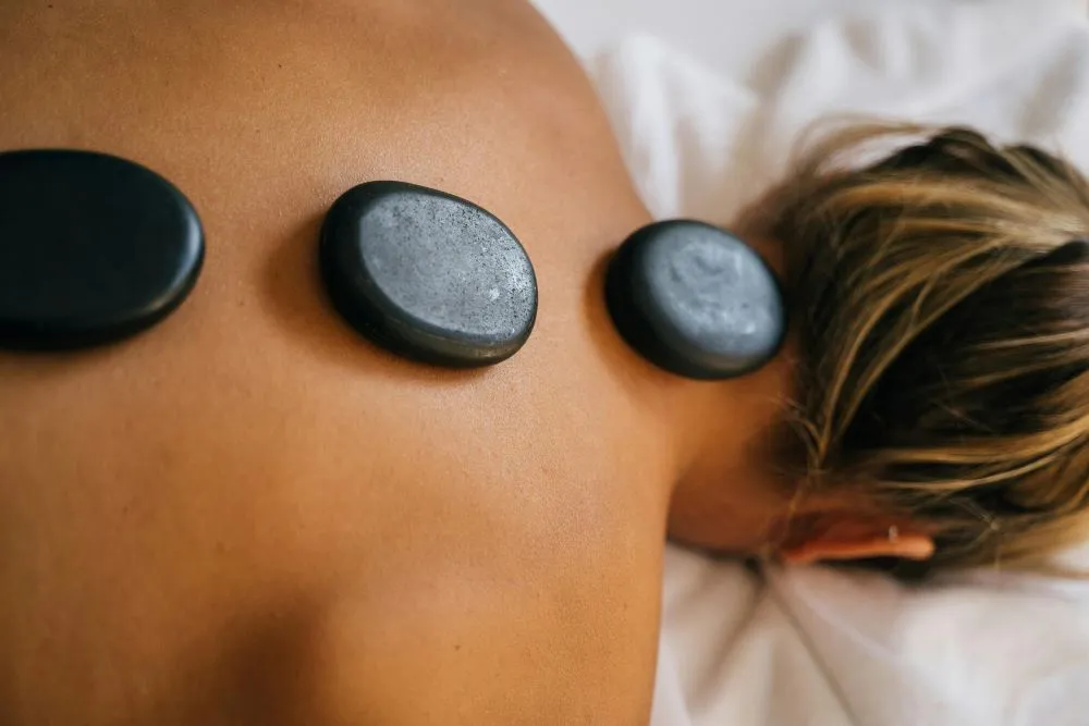 Smooth, heated stones placed on a person's back during a massage.