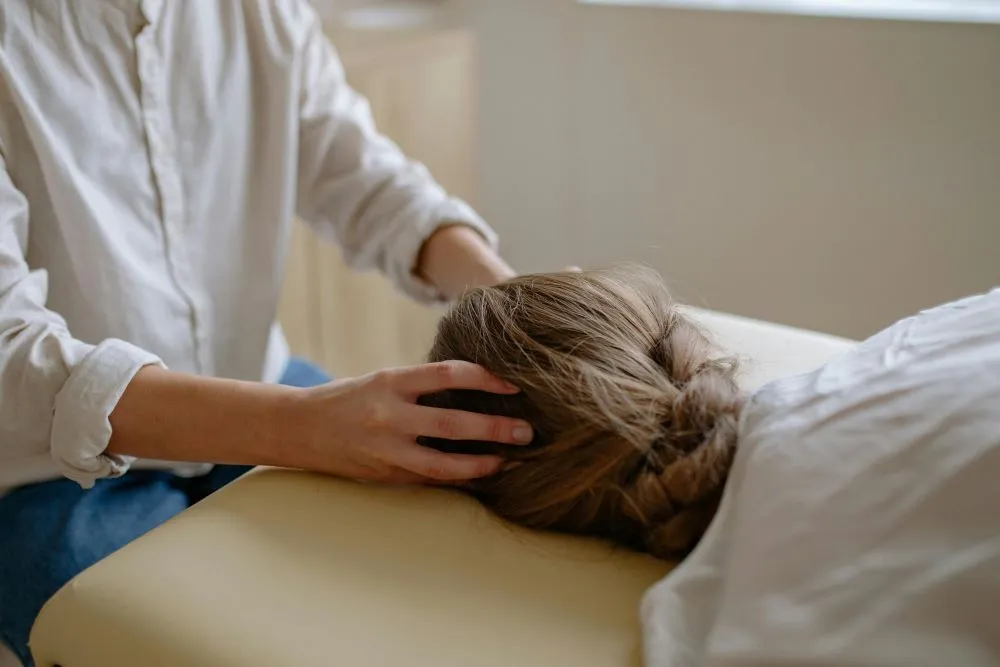 A therapist performing a scalp massage.